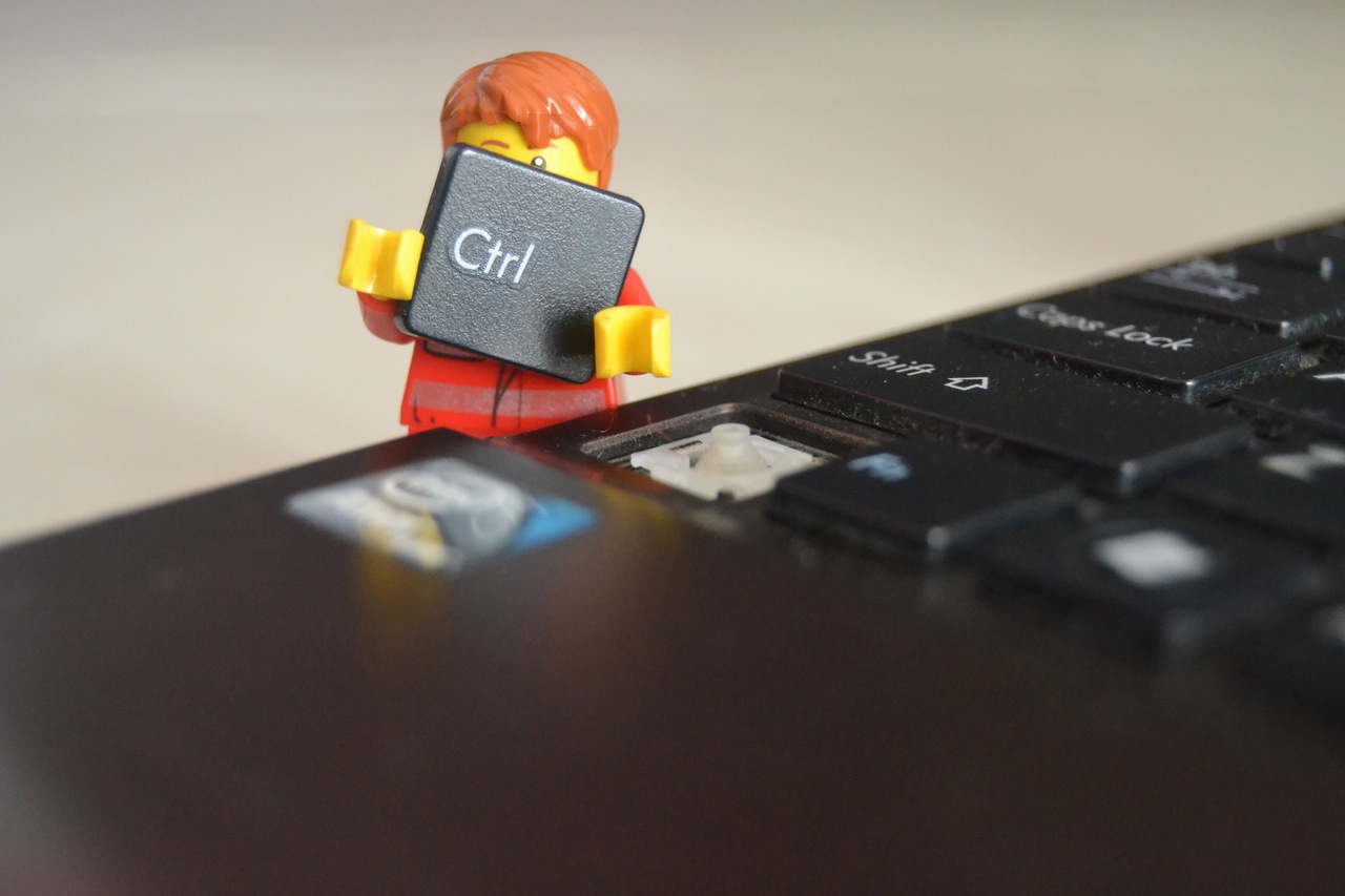 image of a lego man holding a computer key